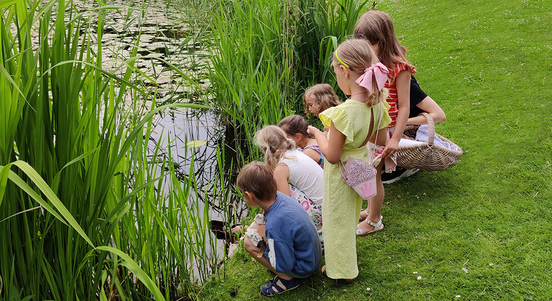 Children by the lake in the garden